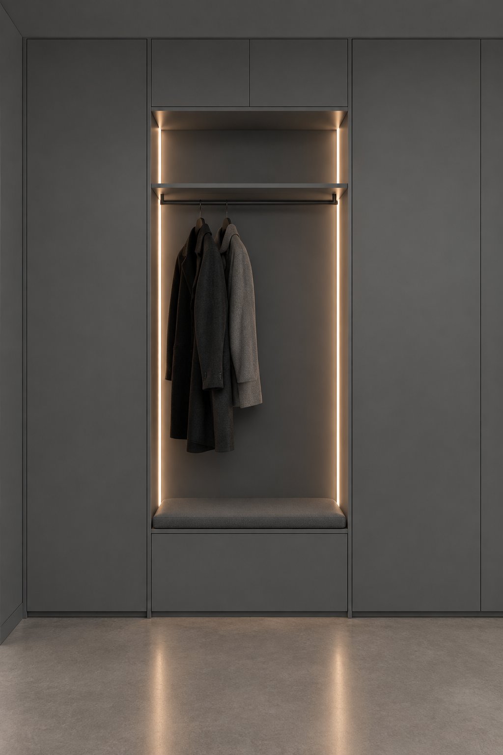 A minimalist entryway niche with tall cabinetry, warm vertical lighting, and a smooth concrete floor.